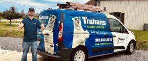 hvac technician standing in front of a van